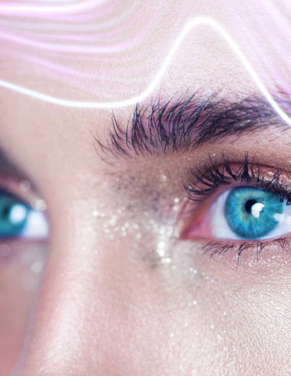 A close-up of a womans face with glittery eye makeup
