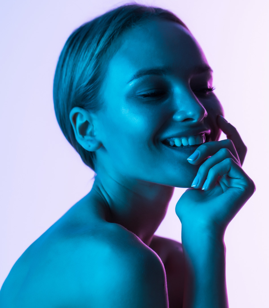 A model holding her face and smiling