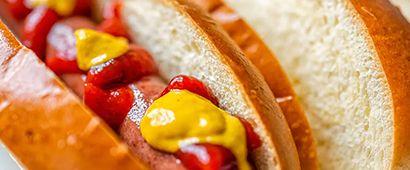 A hot dog with ketchup and mustard in a bun