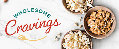 Wholesome cravings banner with some popcorn and other healthy snacks