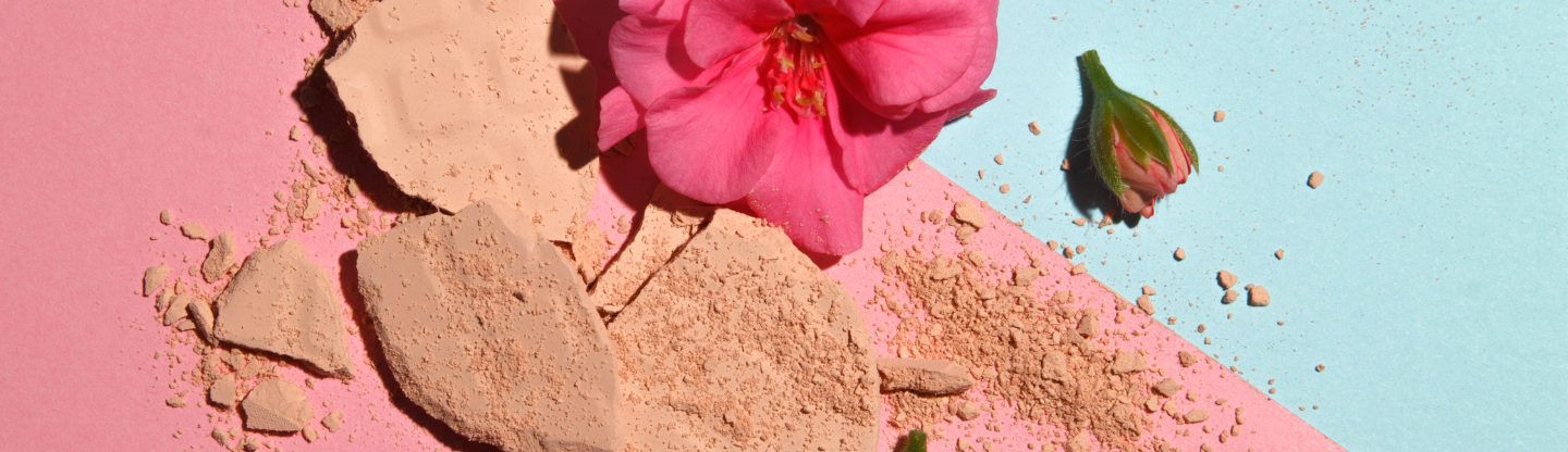 Crumbling cosmetic powder and flowers