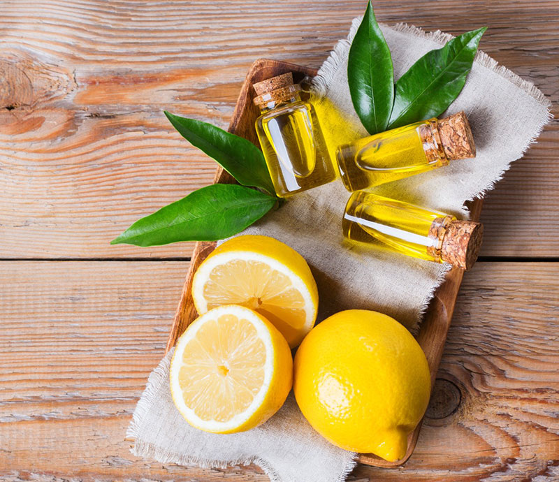 Lemons and Lemon Oil arranged on a table