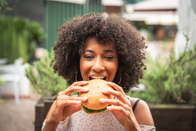 Woman enjoying a plant based burger