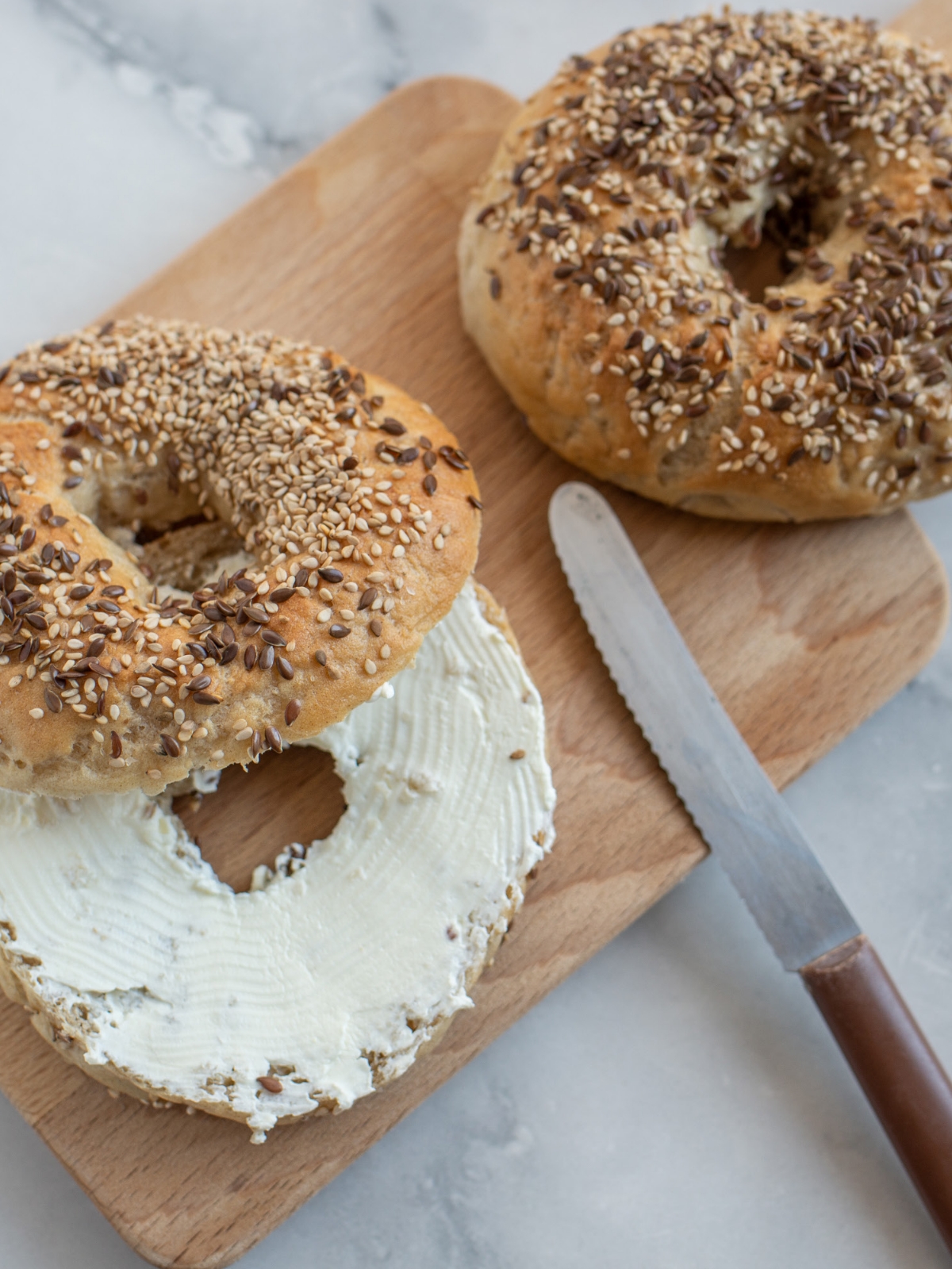 Bagels on a cutting board with plant-based cream-cheese
