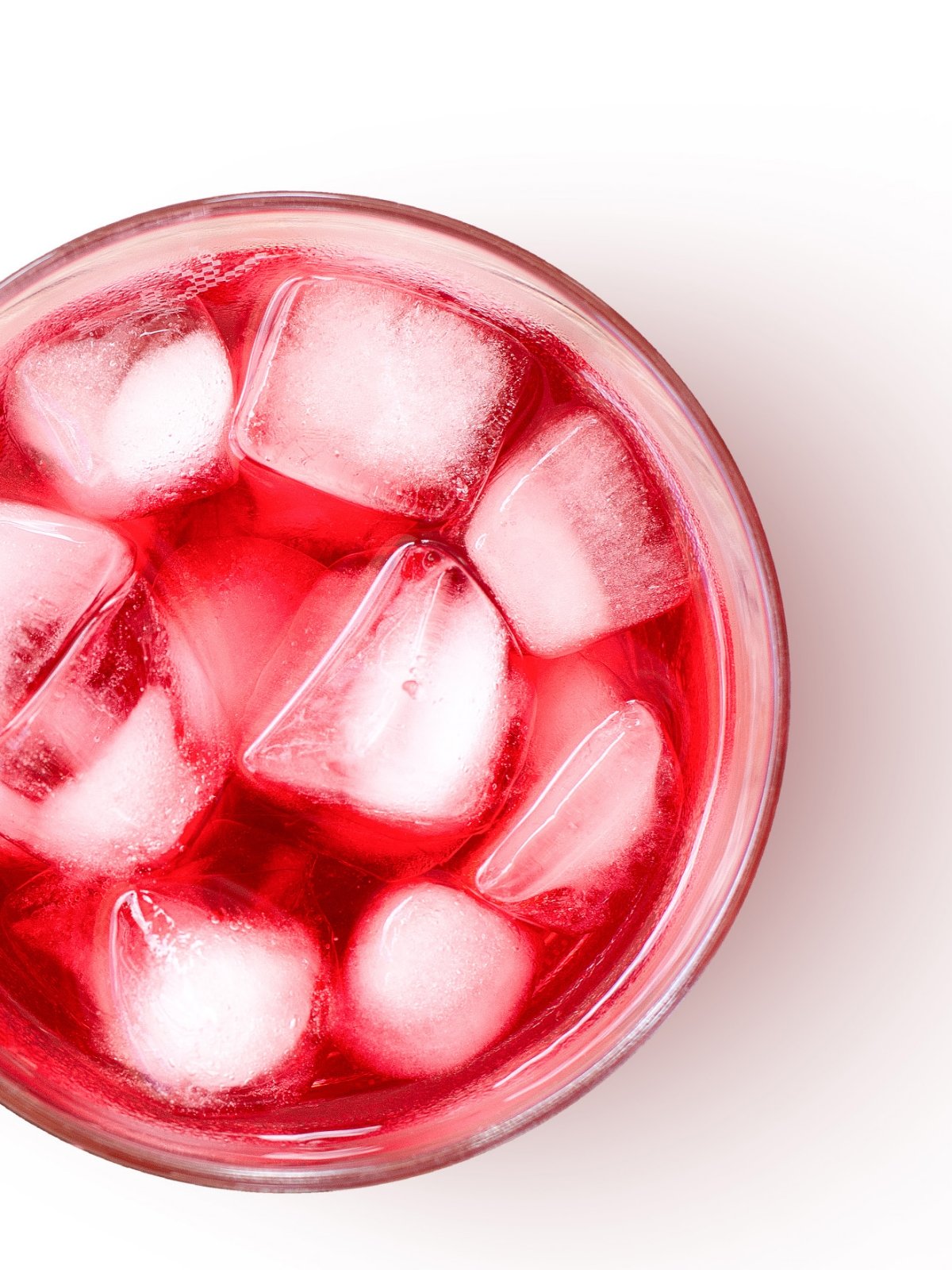 Red beverage in glass with ice