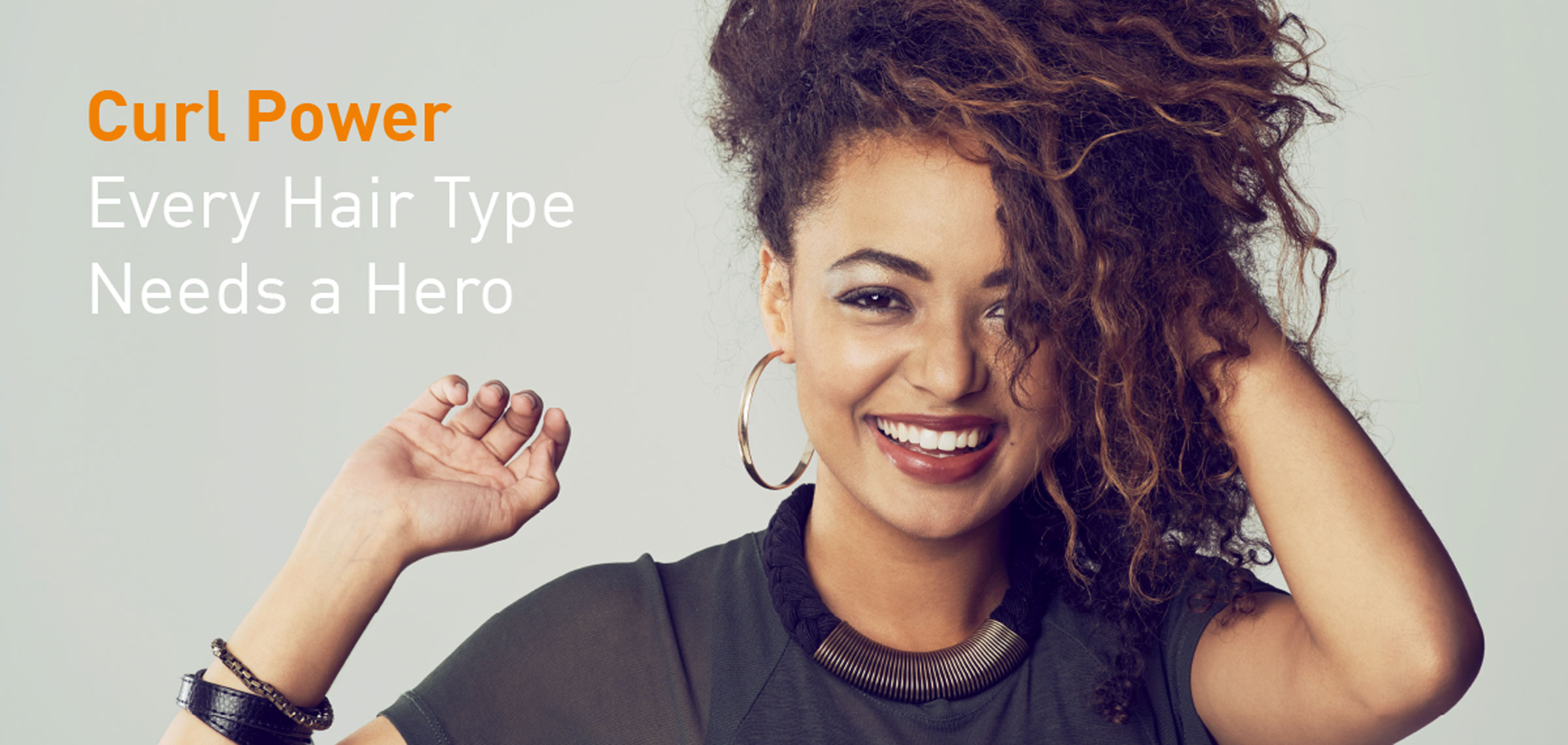 Woman with curly hair next to the words 'Curl Power every hair type needs a hero'