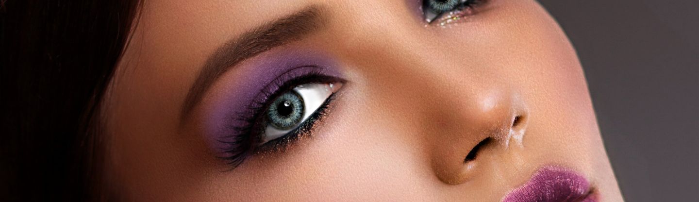 Woman with purple eye makeup and lipstick