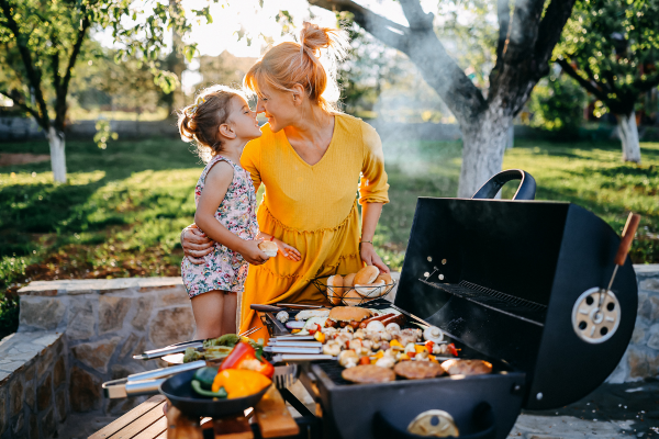 family enjoying a bbq in the summer sun