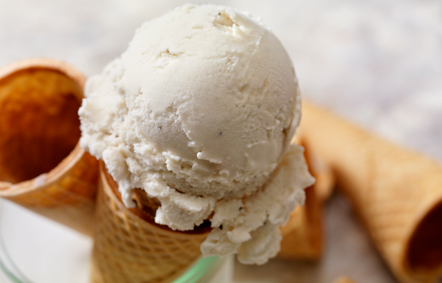 Vanilla flavored ice cream ontop of a cone