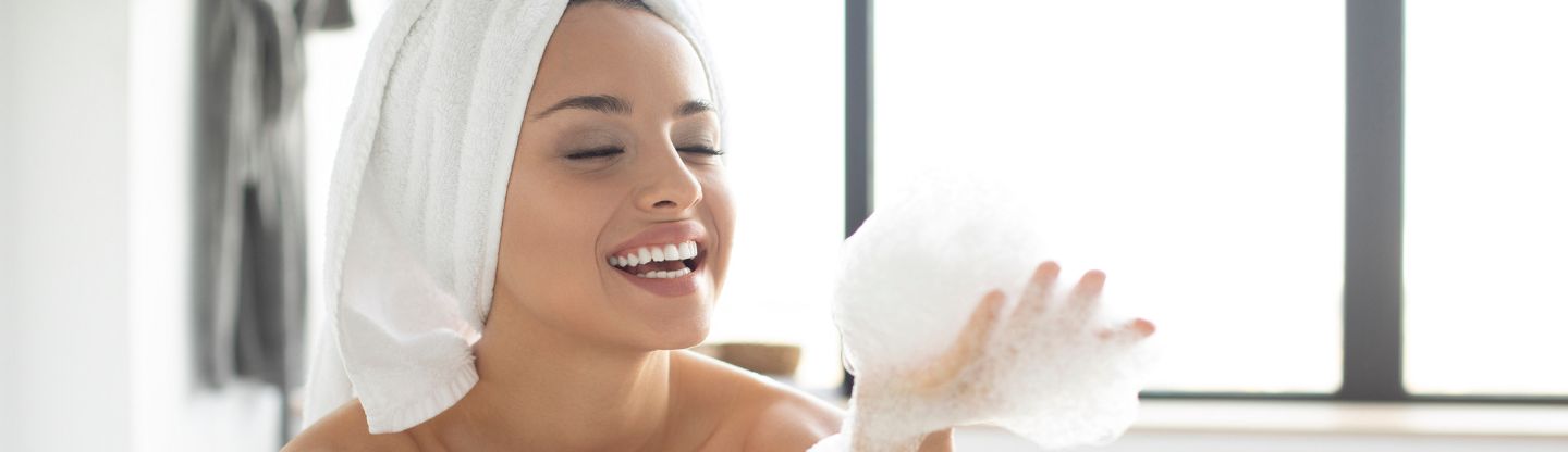 Woman holding bubbles from bubble bath